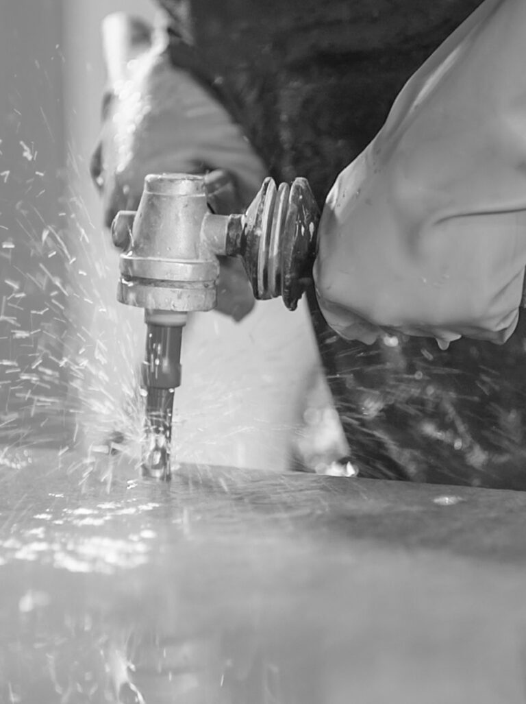 Man drilling in Caesarstone countertop