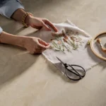 Caesarstone Porcelain 584 Opal Taj surface with hands